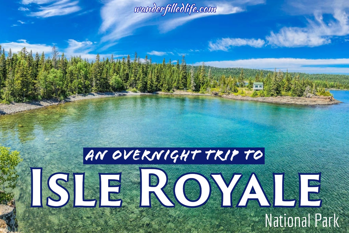 Photo with text overlay. Photo shows a small bay with blue-green waters surrounded by a tree-covered land. Text reads An Overnight Trip to Isle Royale National Park.