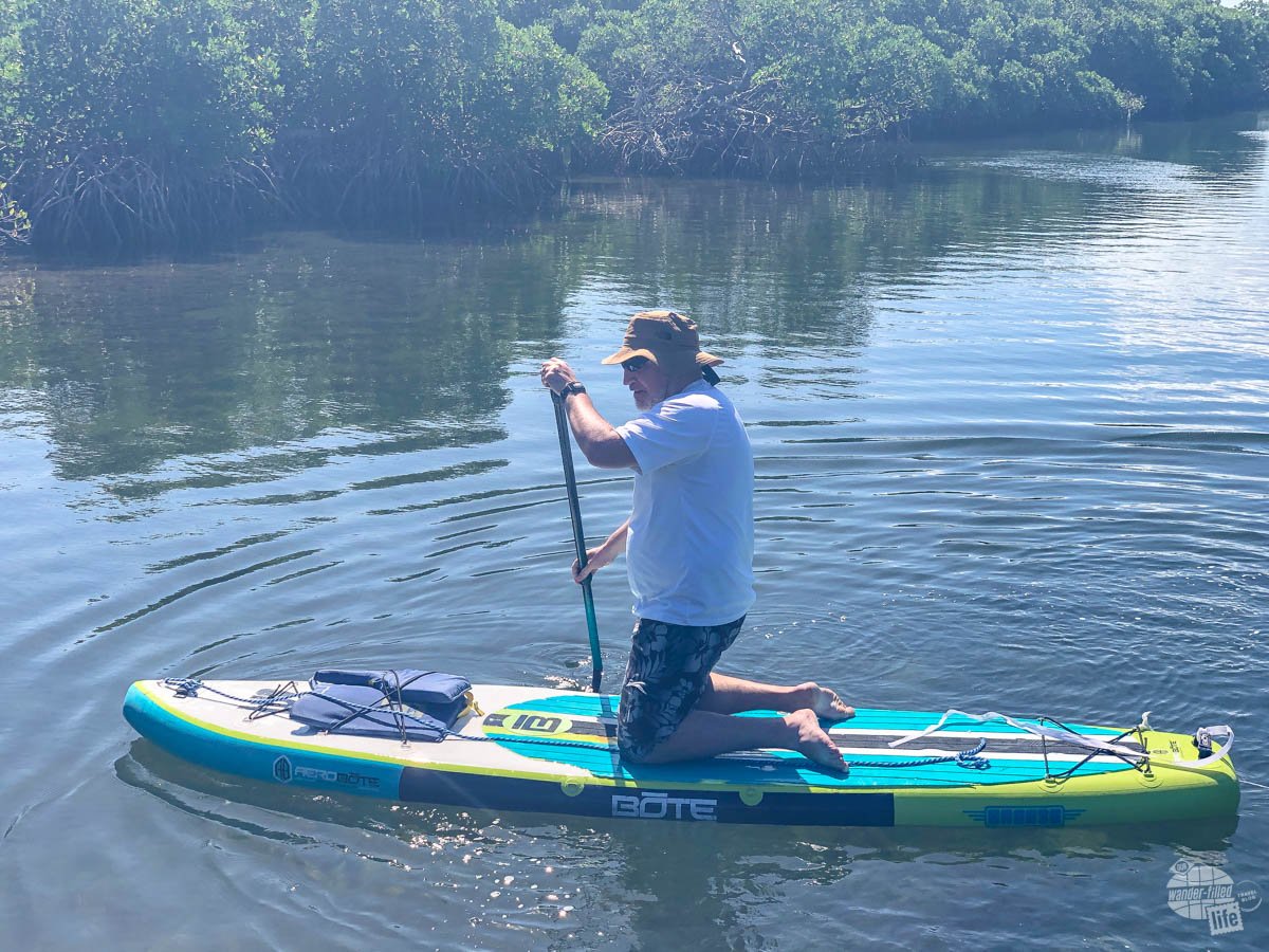 Grant kneels on a paddleboard at Biscayne National Park.