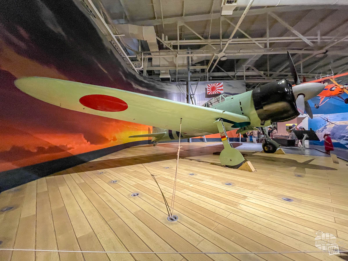 A Japanese Zero fighter on display at a museum.