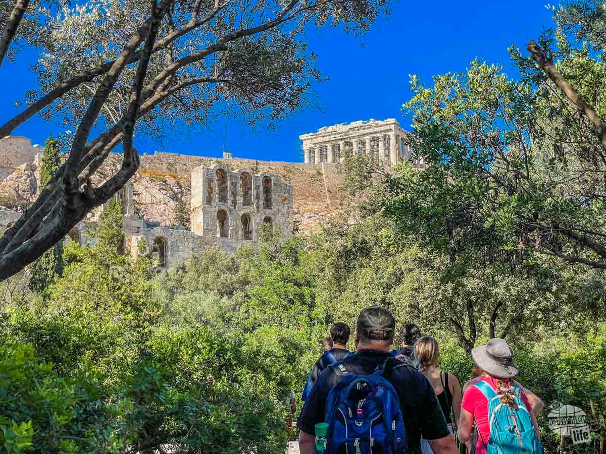 A group of people walking towards the Acropolis.
