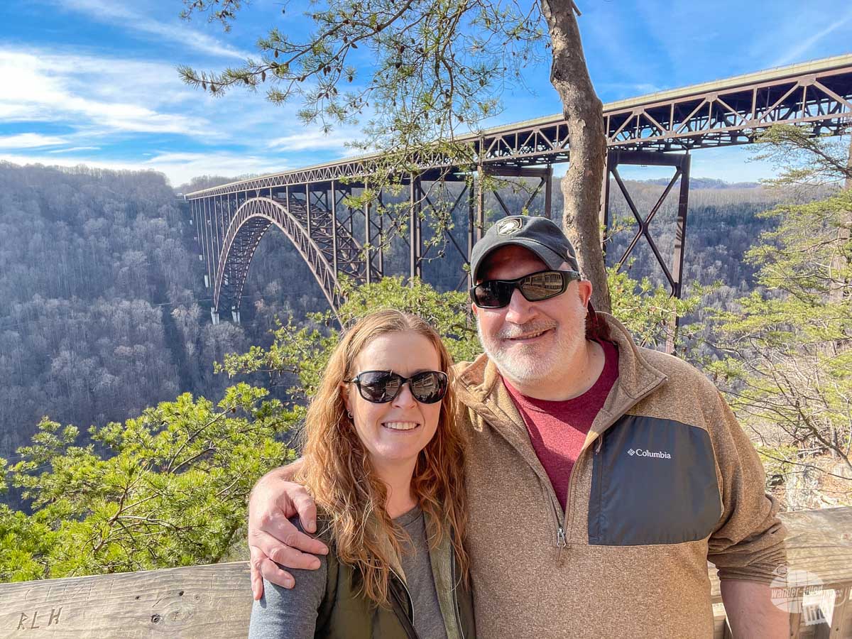Bonnie and Grant pose in front of a bridge over a deep gorge.