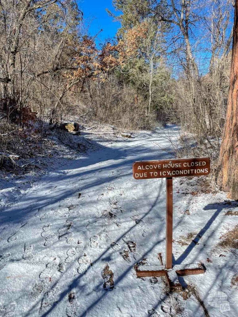 A sign states that the trail is closed due to icy conditions.