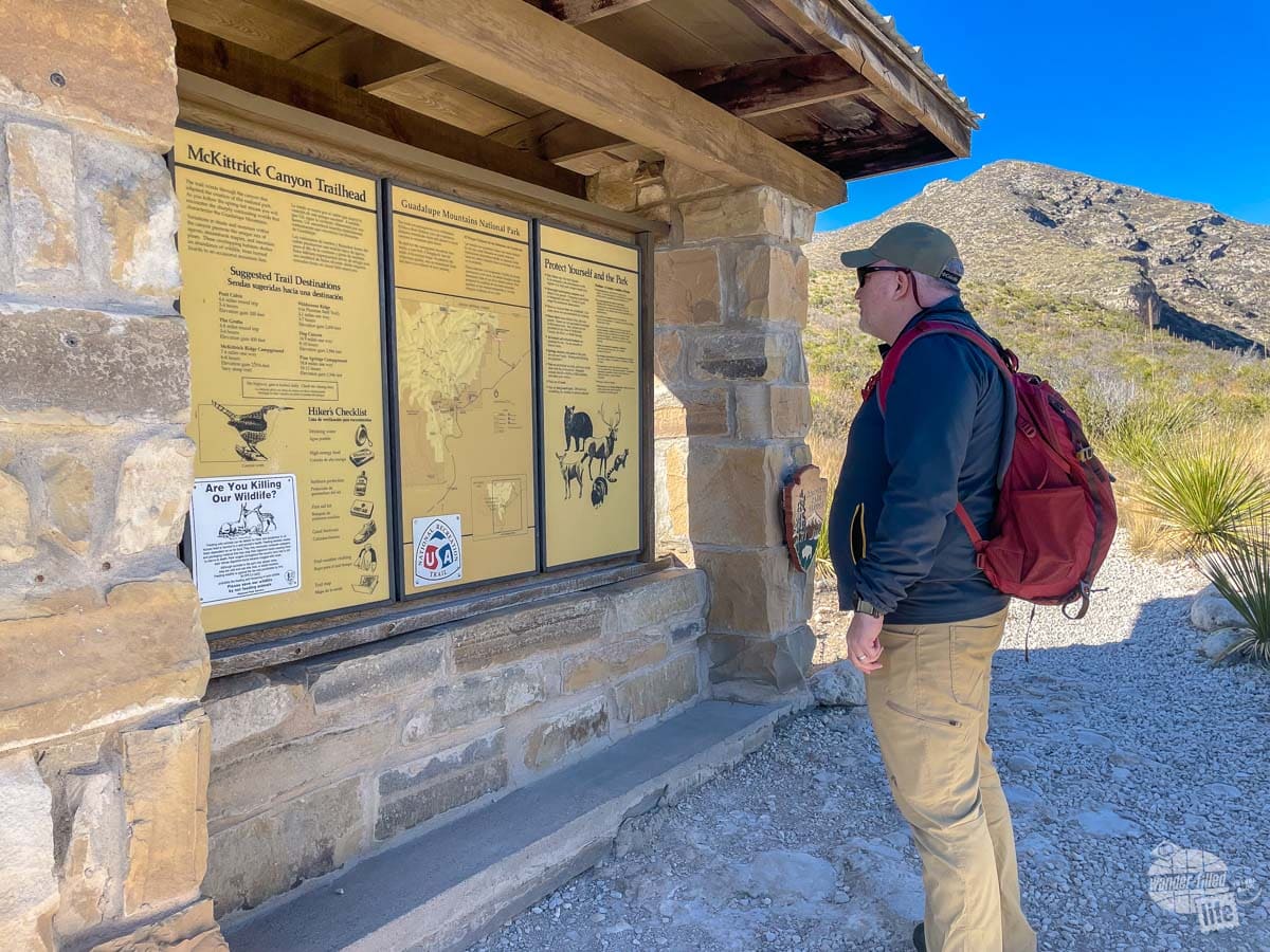 Reading the informational sign at the trailhead at McKittrick Canyon in Guadalupe Mountains National Park