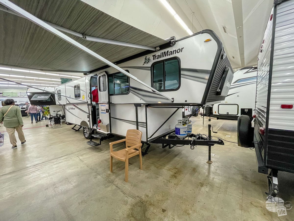A hard-sided pop-up camper at an RV show
