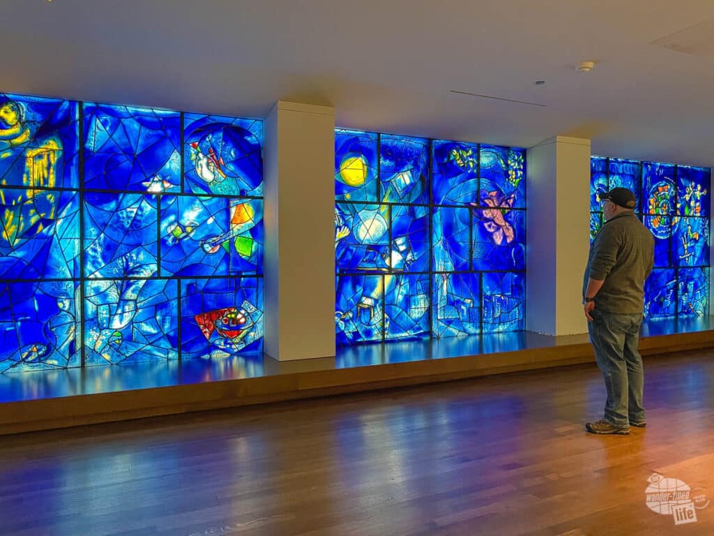 Grant looks onto the blue stained glass Chagall Windows.