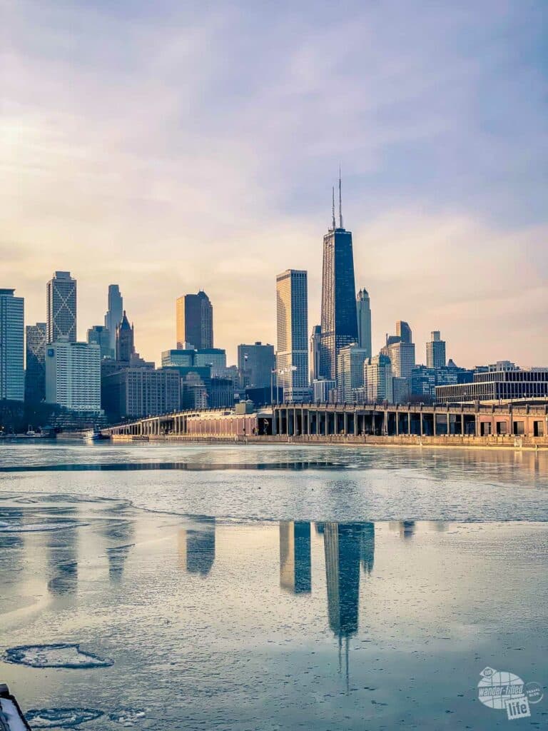 The skyline of Chicago reflected in the icy Lake Michigan.