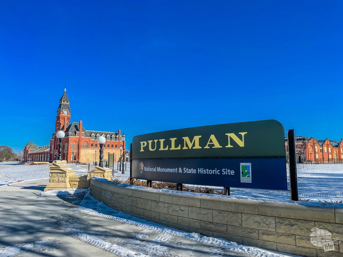 A large sign identifies Pullman National Monument & State Historic Site with an old clock tower building in the background.