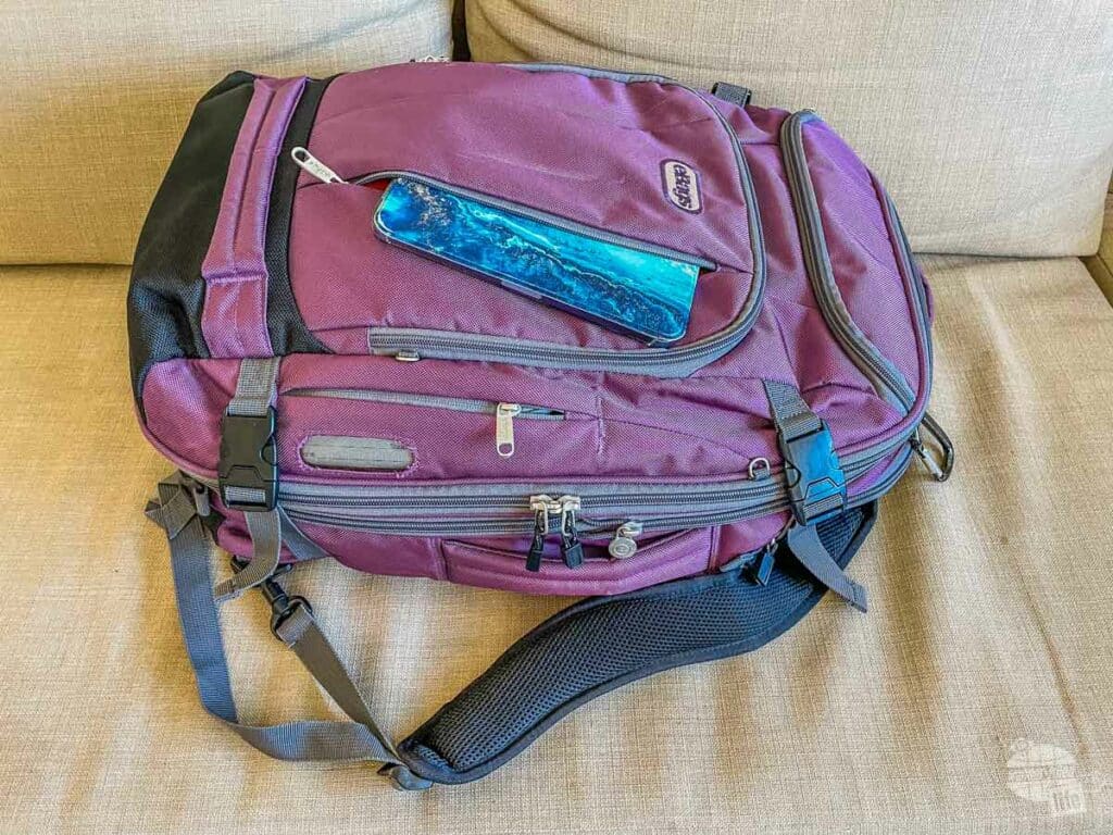 Purple travel backpack with an iPad mini tucked into the front pocket.