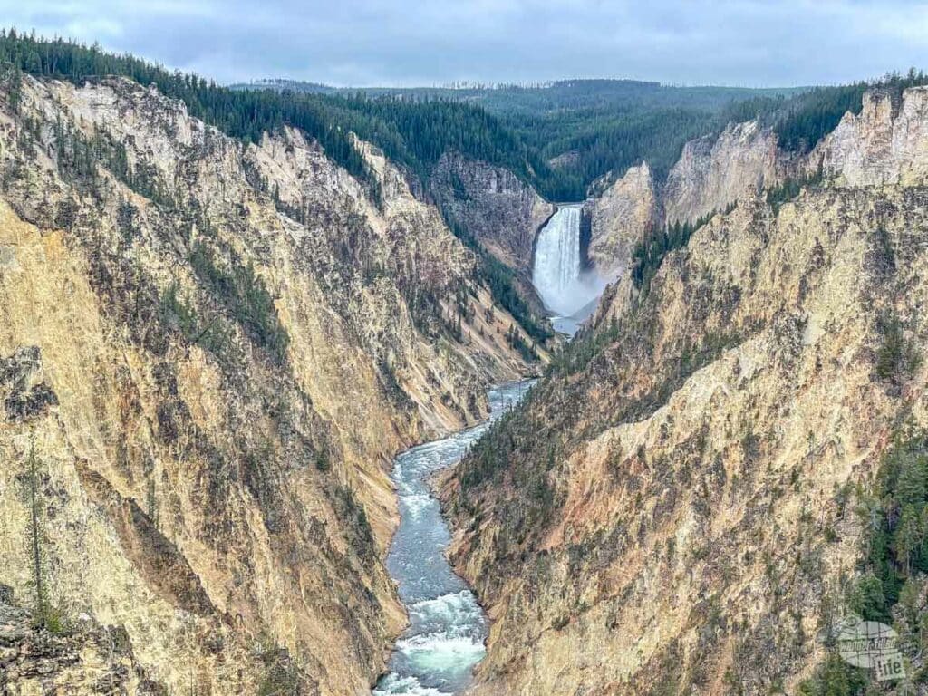 A river tumbles down a waterfall and through a canyon.