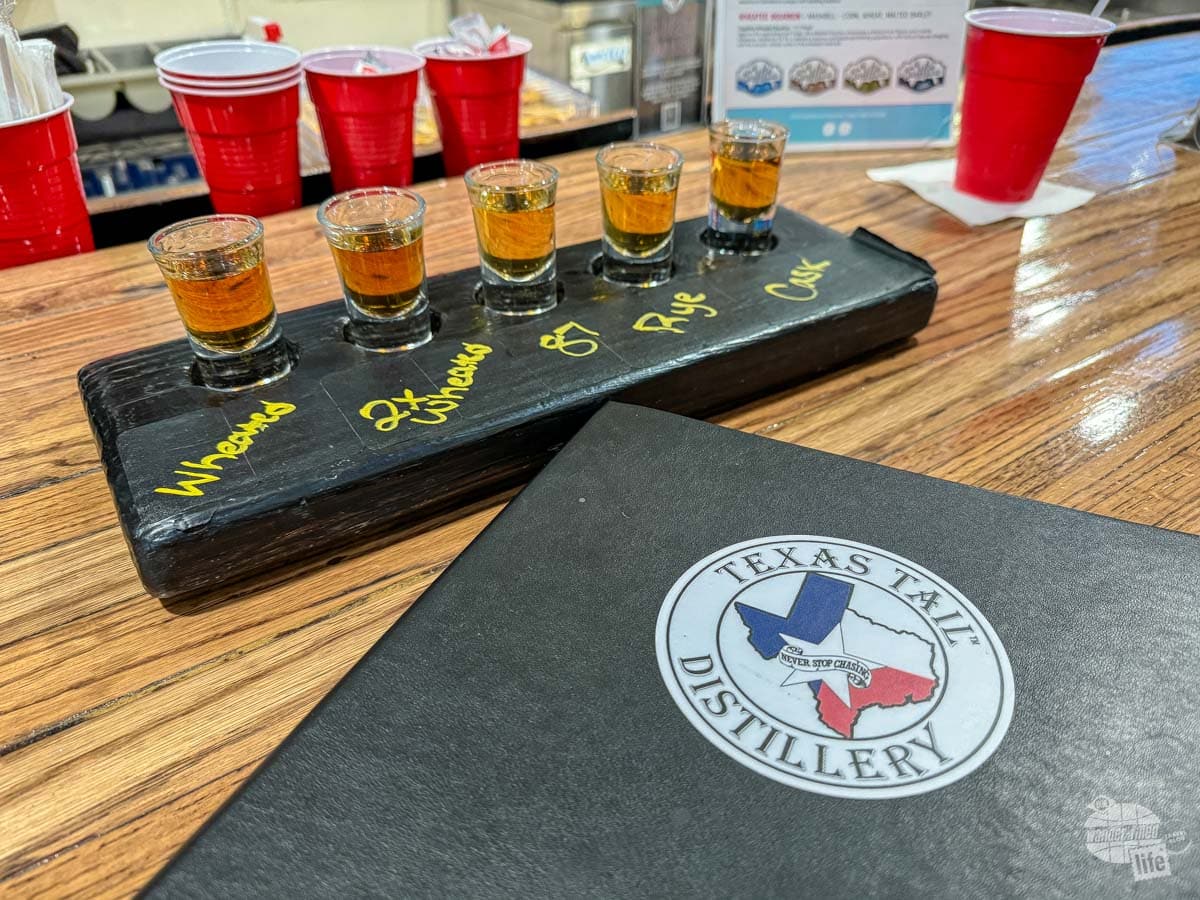 A flight of 5 whiskey samples.
