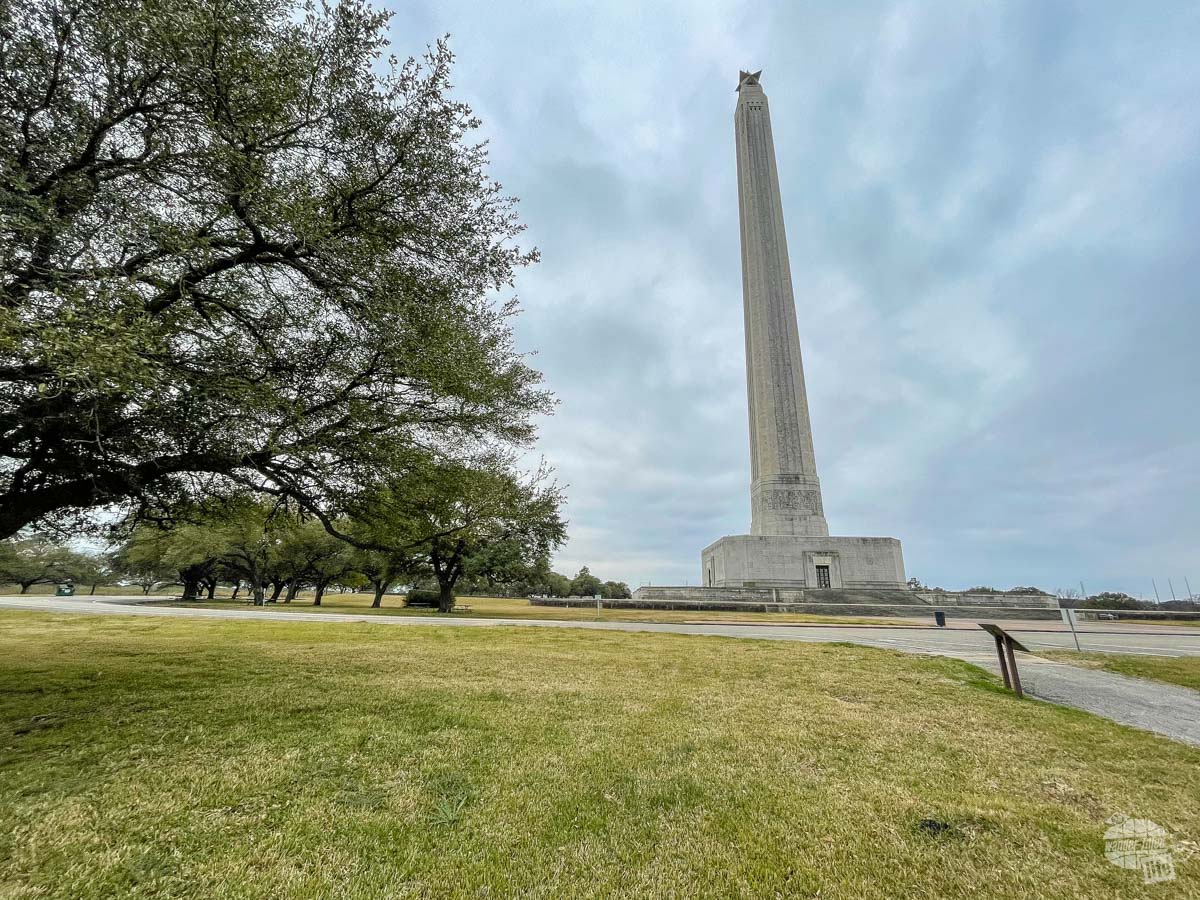 A tall monument in a park. 