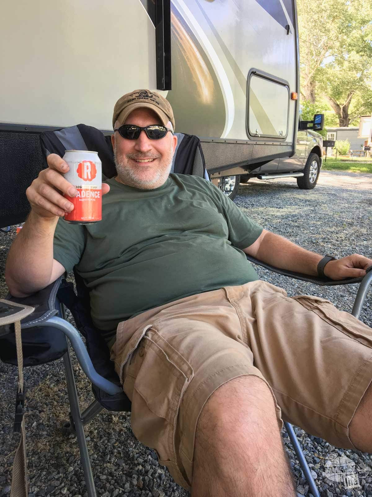 Grant relaxing with a beer after getting everything set up at the campsite on a hot afternoon.