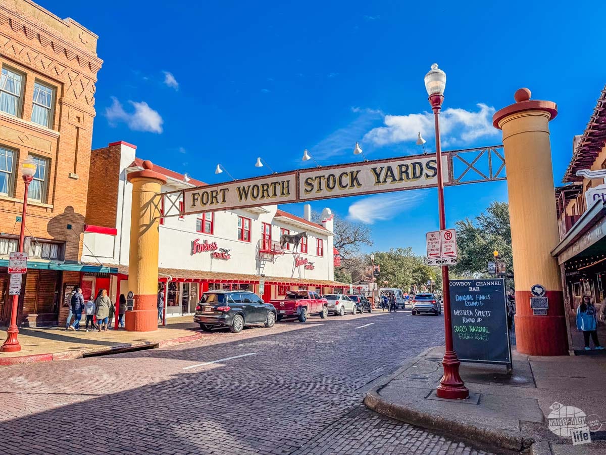 A sign that says Fort Worth Stock Yards spans across a city street. Fort Worth is the last stop on our Texas road trip itinerary.