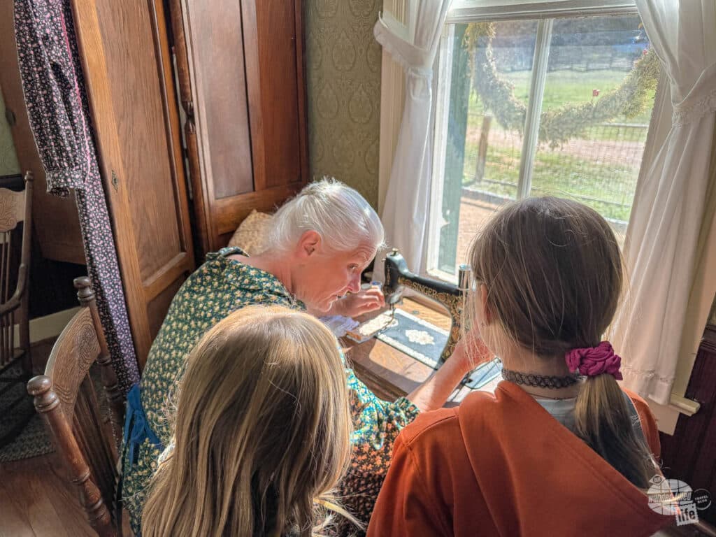 A living historian at the Lyndon B. Johnson State Park and Historic Site demonstrating sewing.