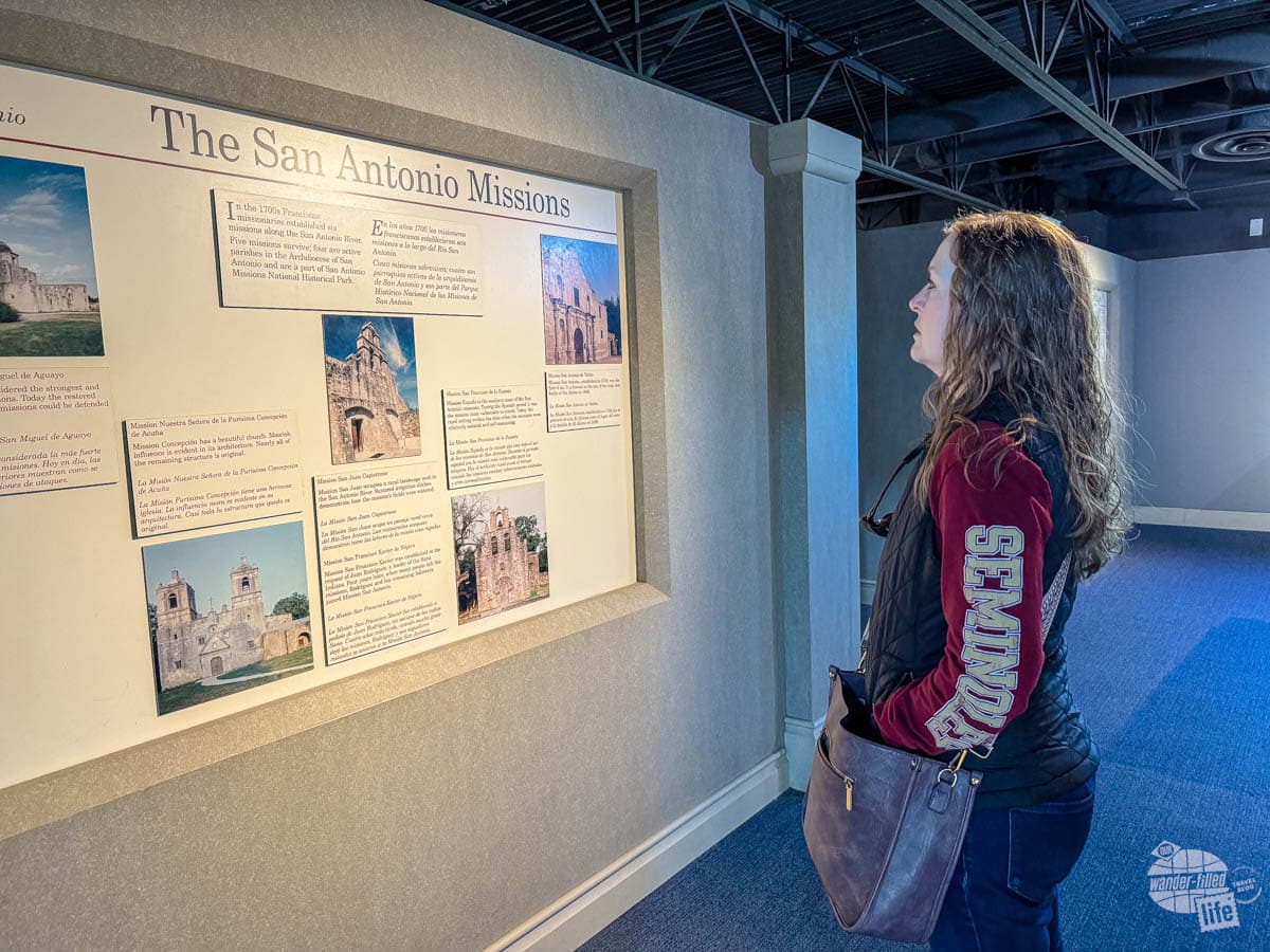 Bonnie Sinclair reading an exhibit at the San Antonio Missions National Historical Park Visitor Center.