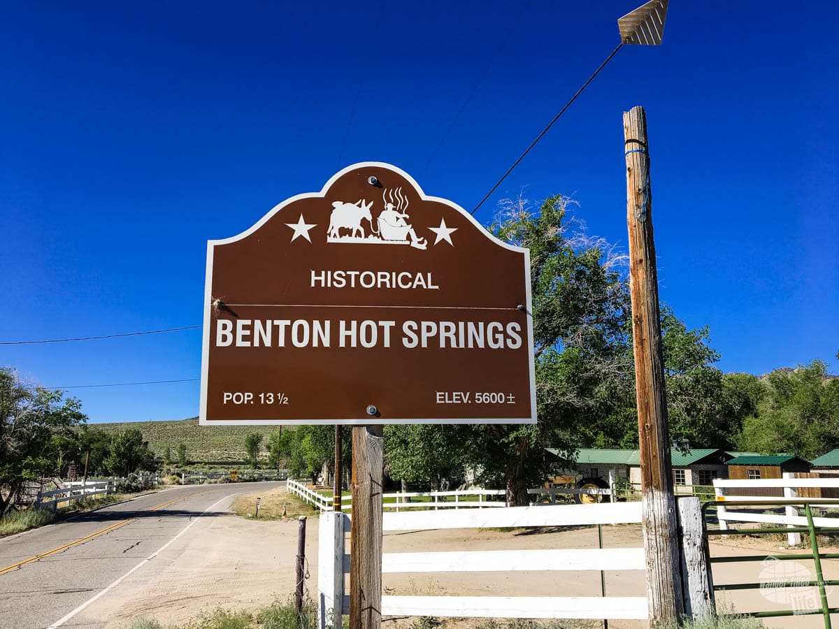 A brown road sign indicated the community of Benton Hot Springs with a population of 13 1/2.