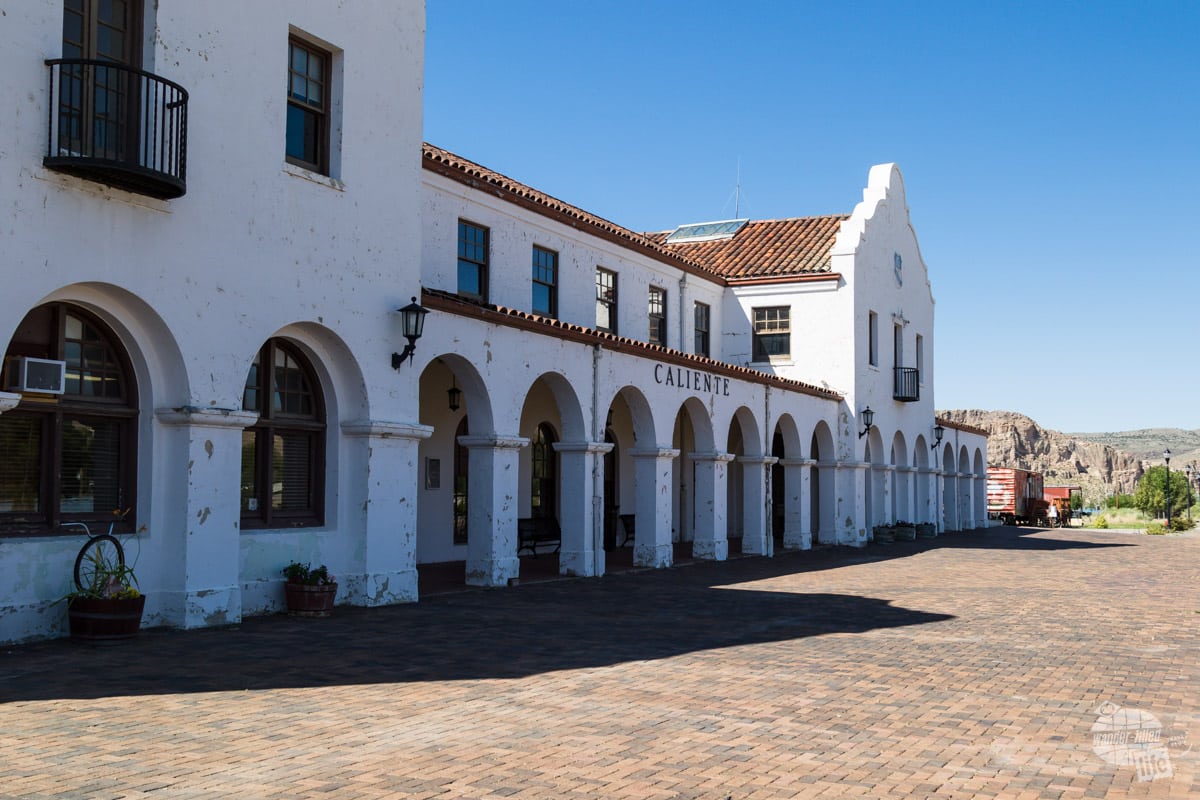A white single story building with Spanish-style arches.
