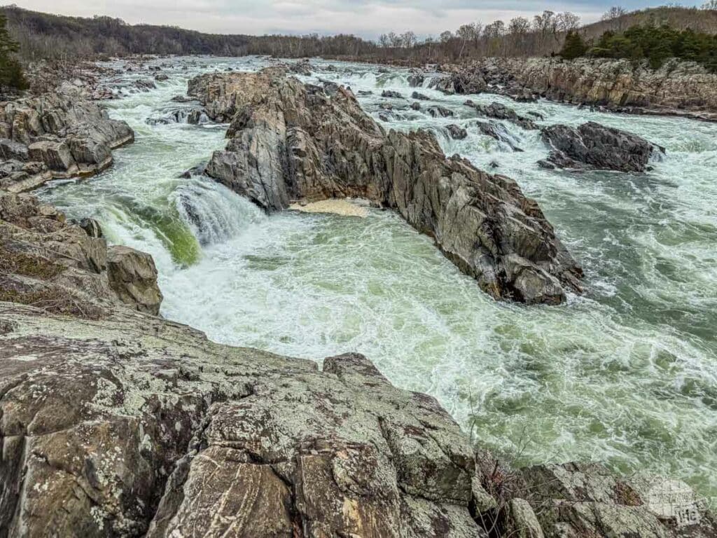 Great Falls Park is part of the George Washington Memorial Parkway. The photo shows the river cascading through a rocky gorge.