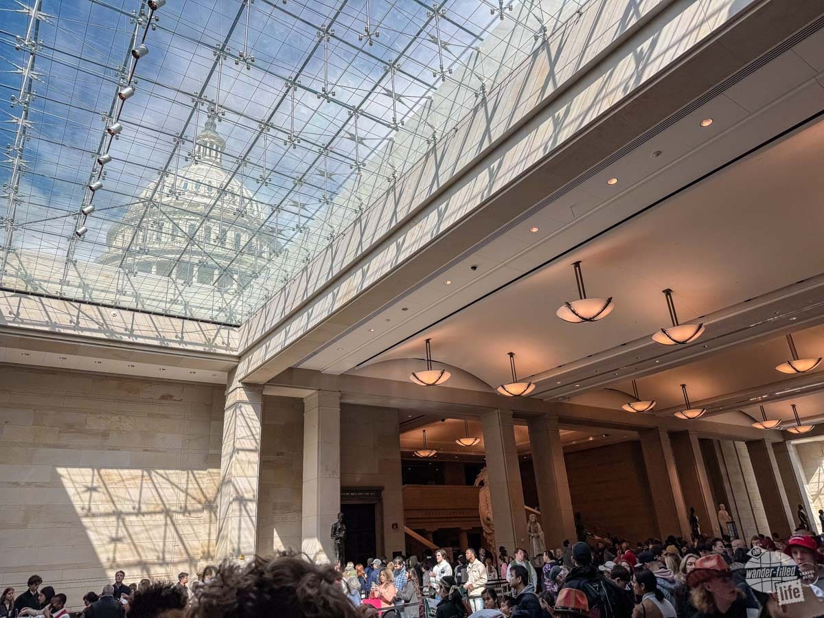 A large, open space with a skylight above. Through the skylight, the Capitol dome is visible.