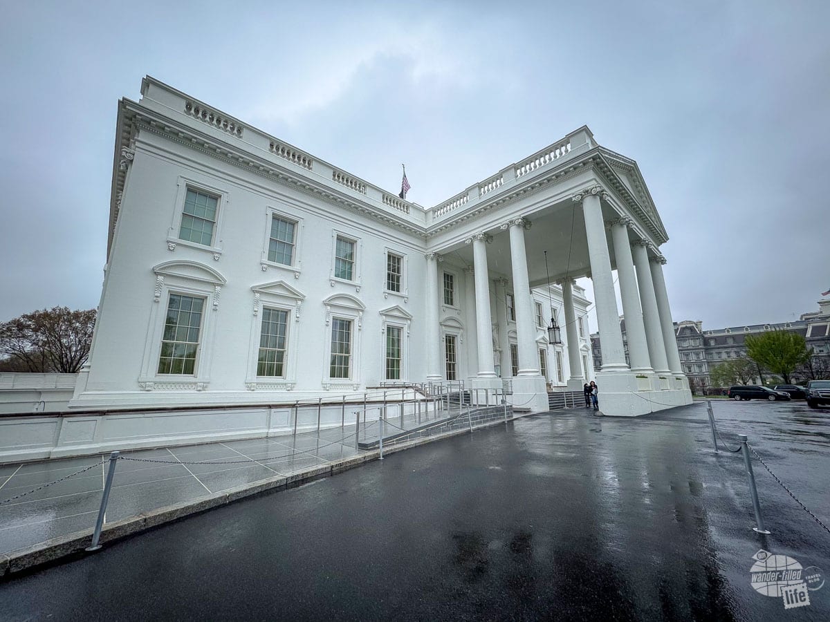 The front of the White House while on a White House tour... an white building with a portico off the front of it with Greek-style columns.