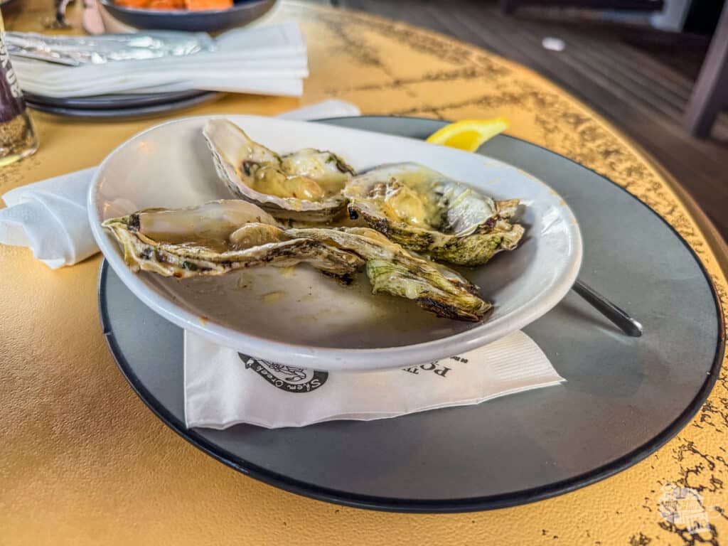 A plate of grilled oysters on a table