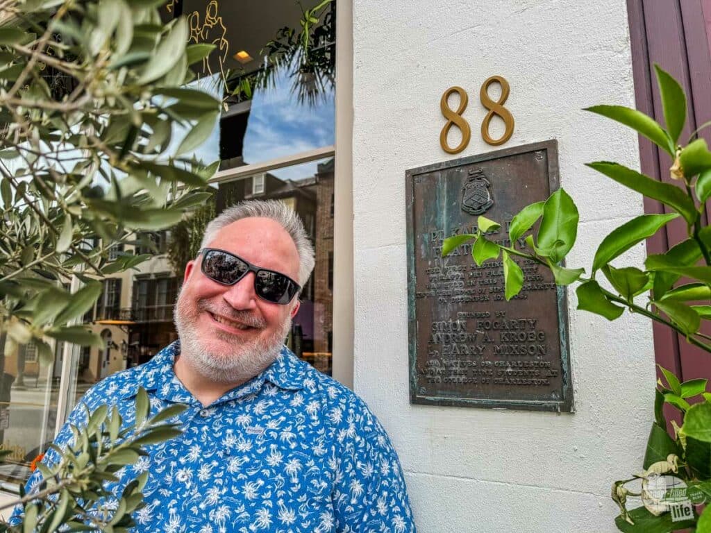 Grant standing beside a bronze plaque with the number 88 above it.