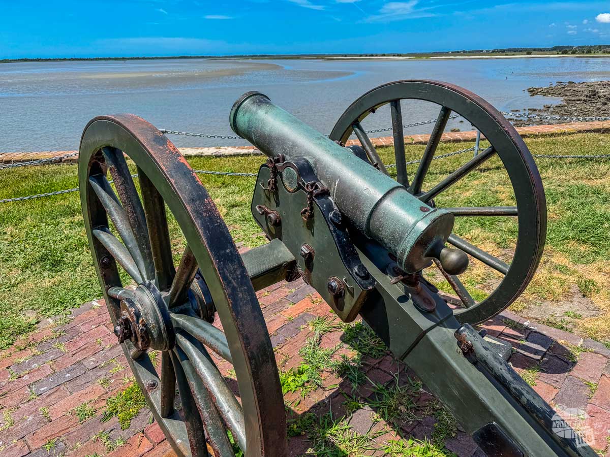 A cannon on a wheeled carriage overlooking Charleston Harbor.