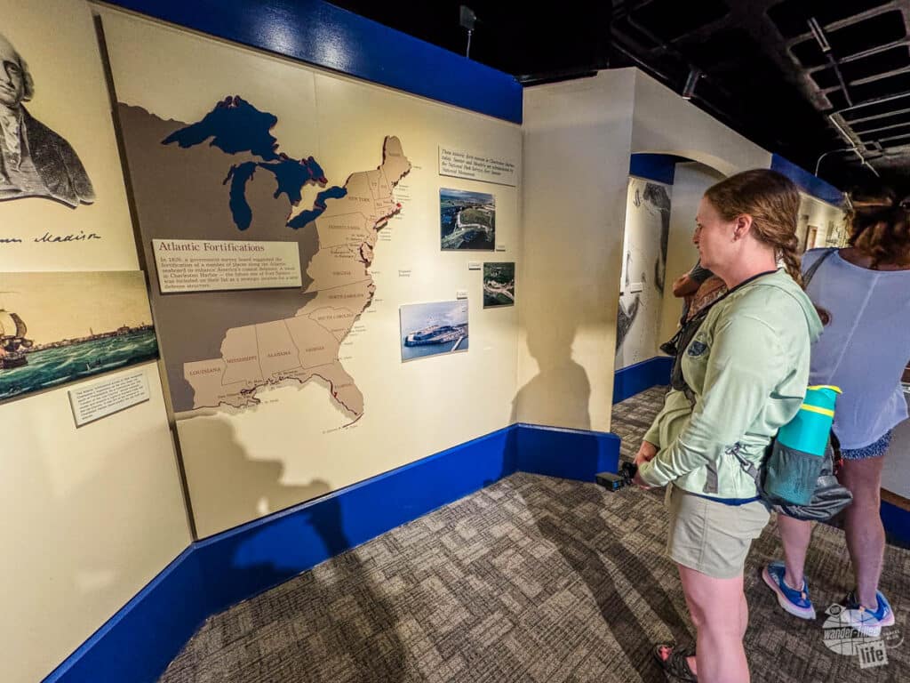 A woman looking at an exhibit about the fortifications along the Atlantic and Gulf coasts inside the museum at Fort Sumter.