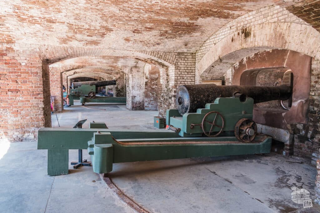 A long hallway under masonry cover with a large cannon on a gun carriage at Fort Sumter.