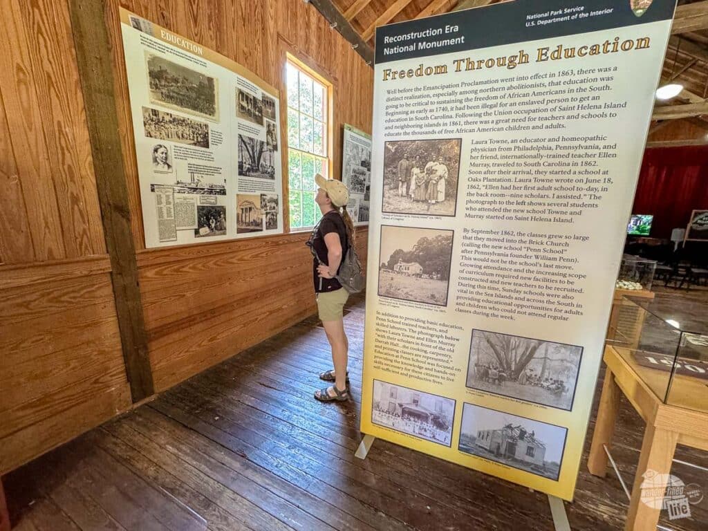 A woman looking at an exhibit on Reconstruction era education